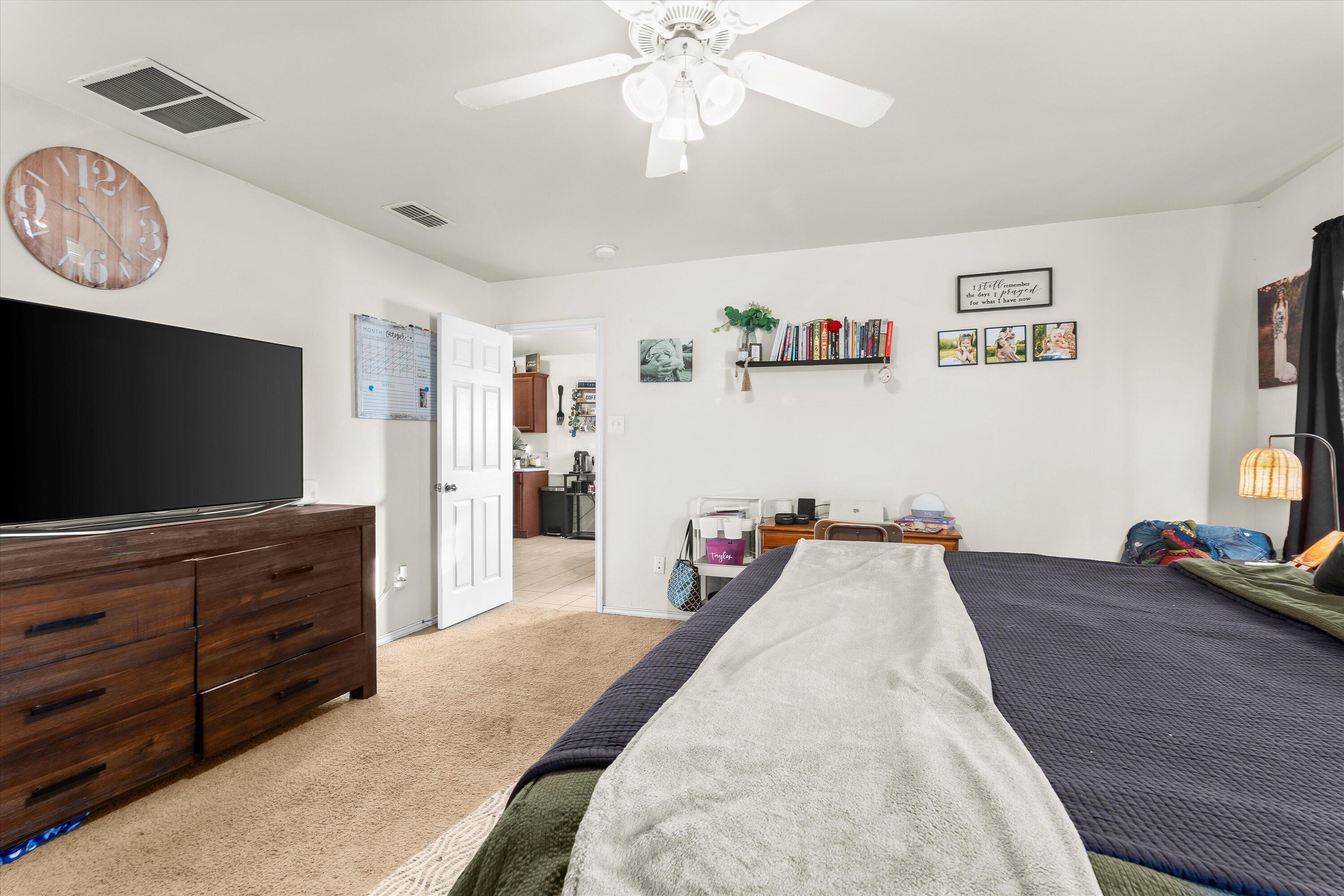 6513 85th Street Lubbock, TX 79424 - Photo 13 of 22 a living room with furniture and a flat screen tv