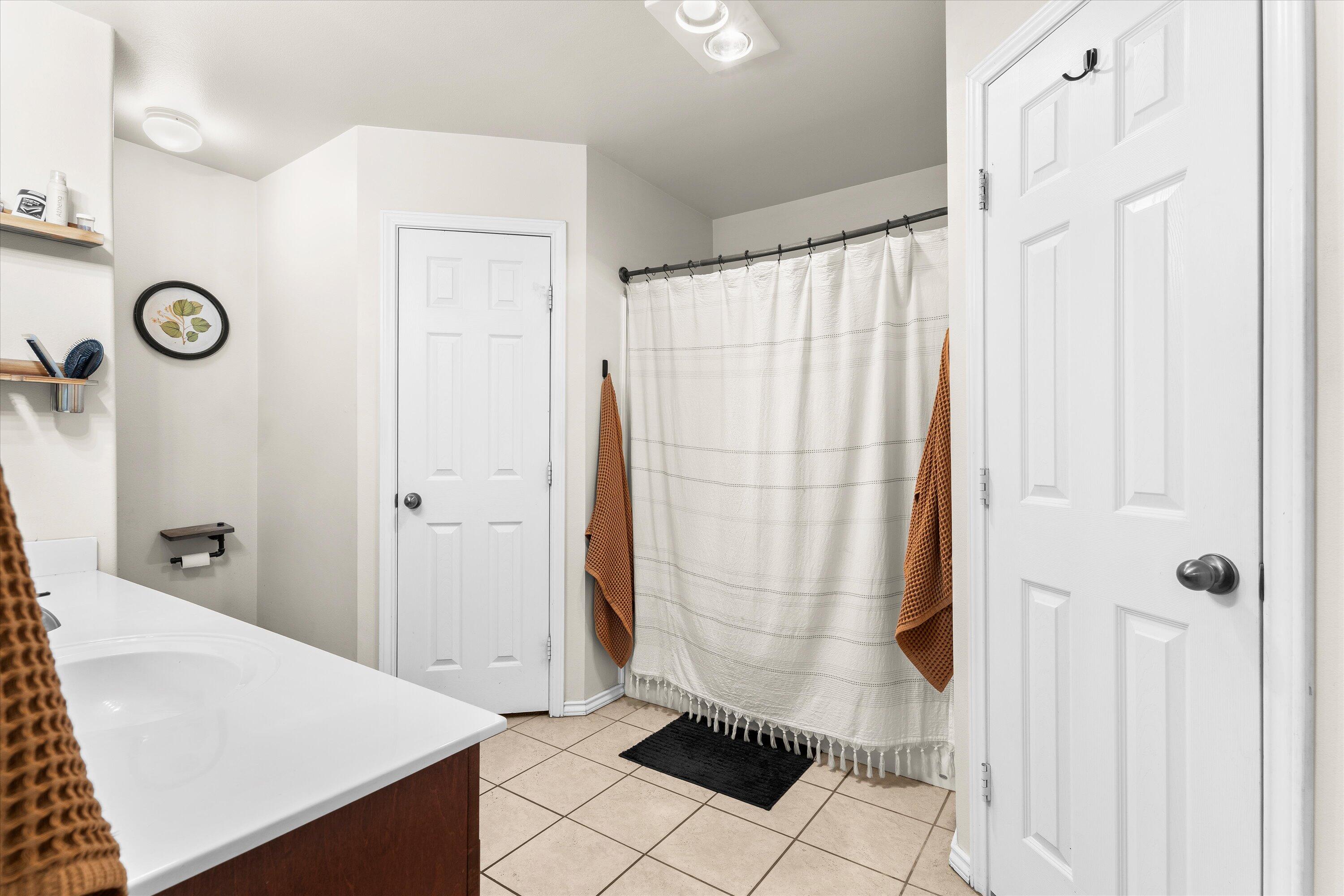 6513 85th Street Lubbock, TX 79424 - Photo 14 of 22 a bathroom with a shower and a sink
