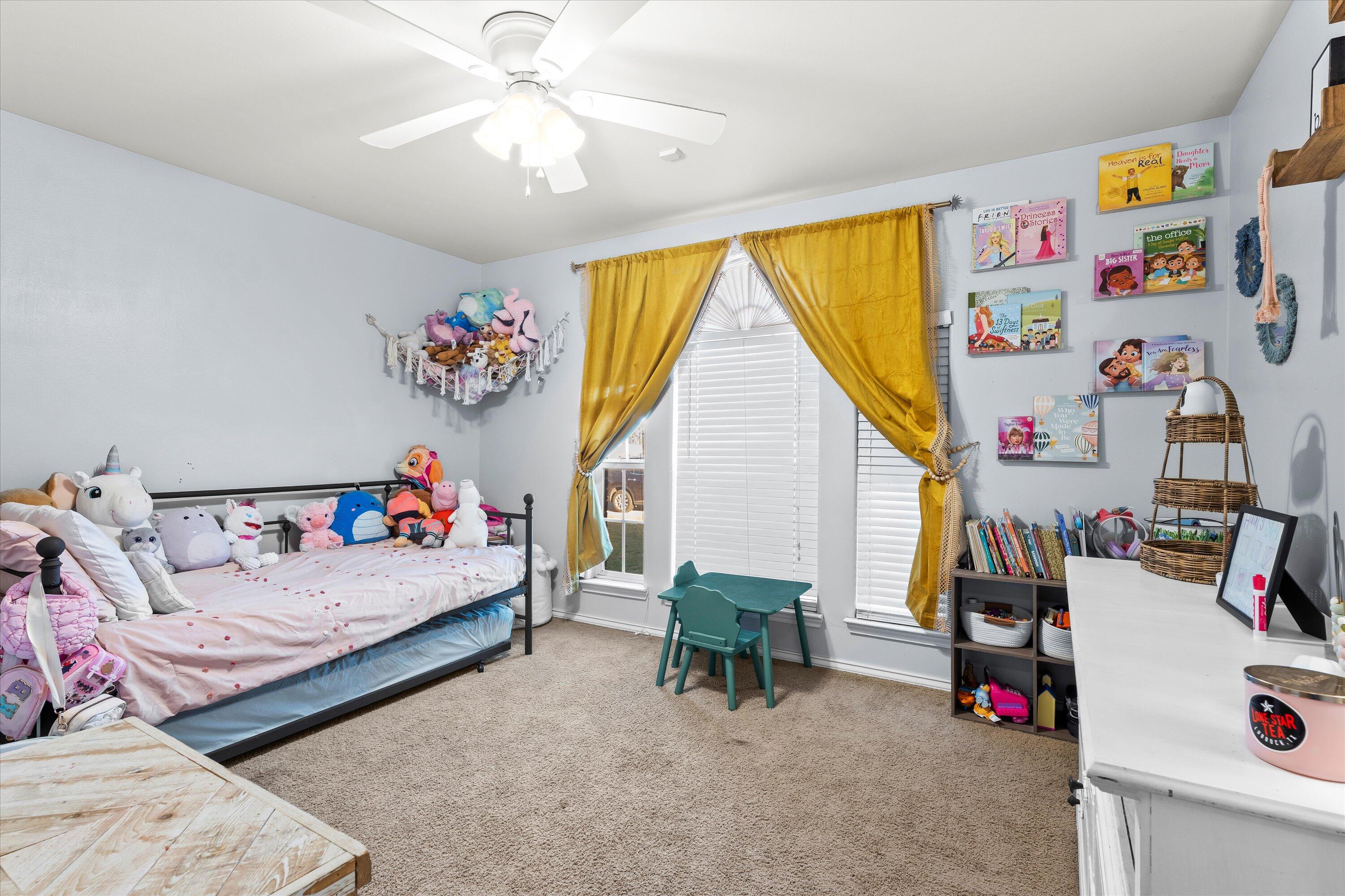 6513 85th Street Lubbock, TX 79424 - Photo 16 of 22 a bed room with a bed and a couch