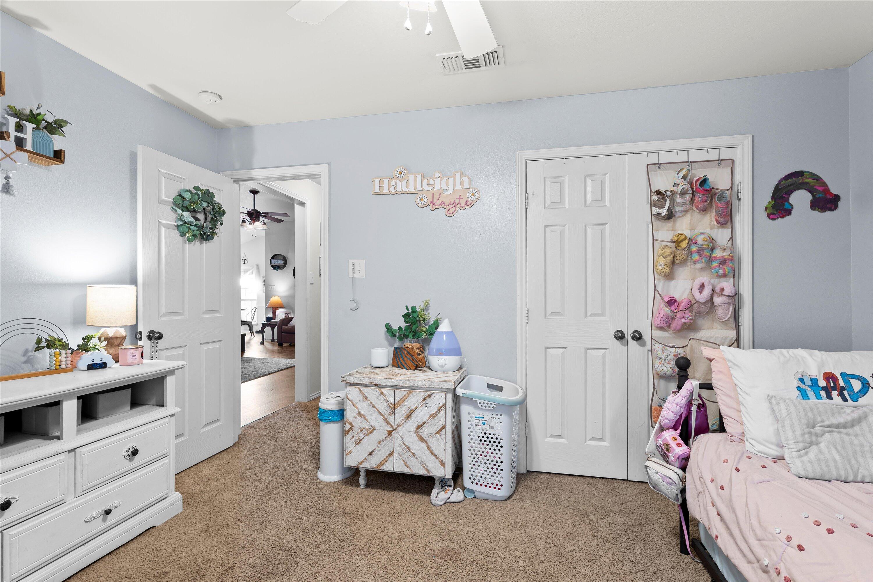 6513 85th Street Lubbock, TX 79424 - Photo 17 of 22 a bedroom with furniture and a bed