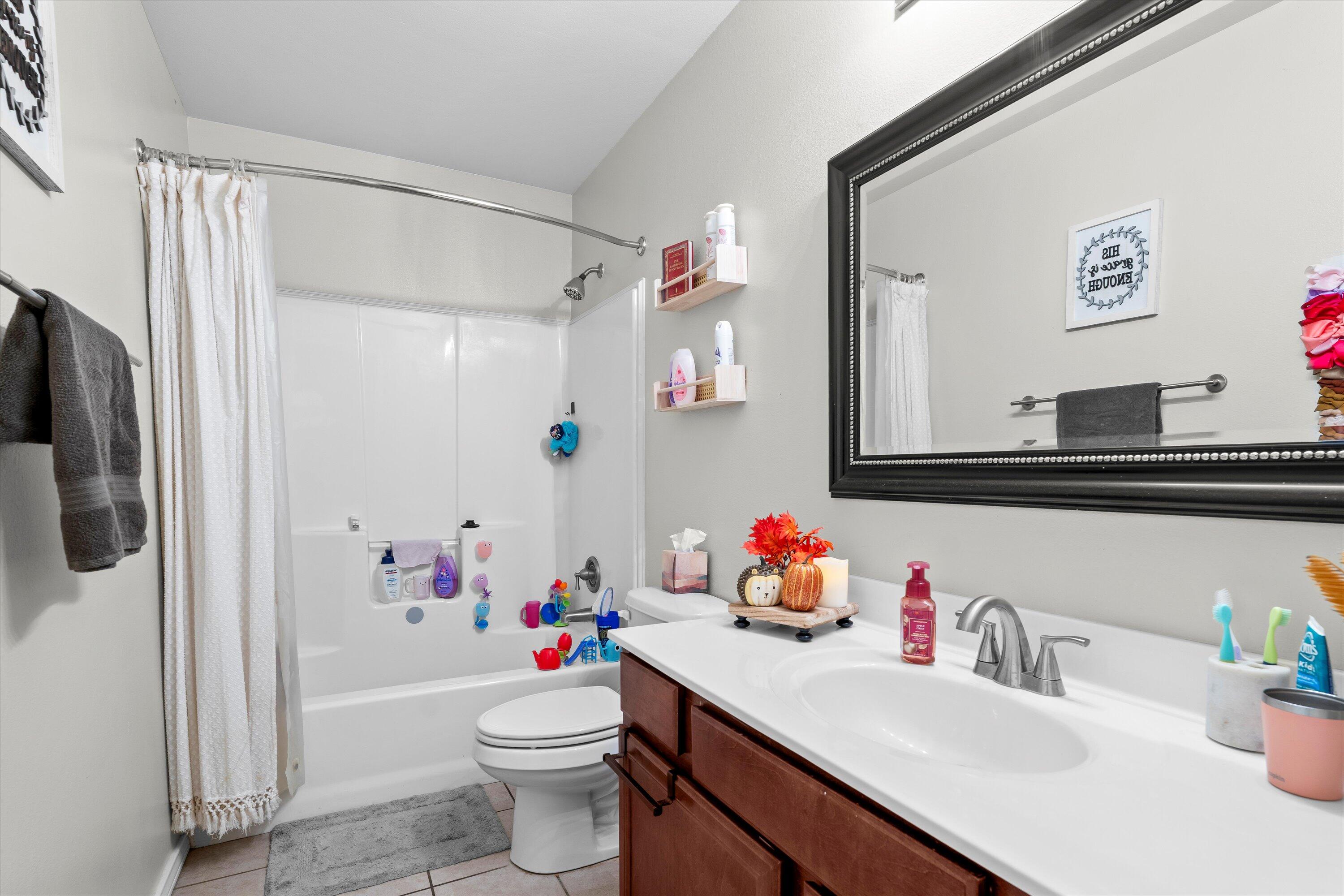 6513 85th Street Lubbock, TX 79424 - Photo 18 of 22 a bathroom with a sink toilet and shower