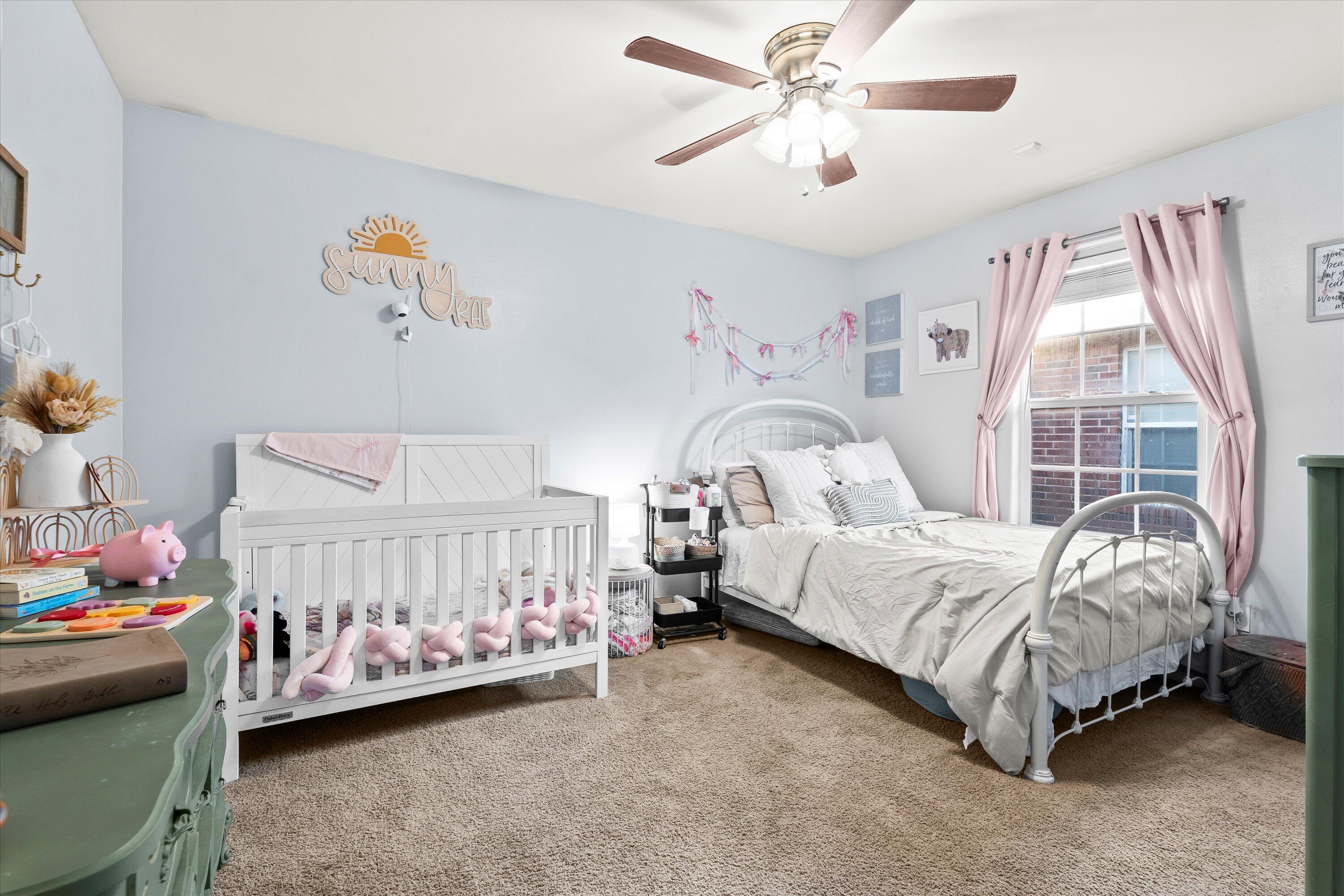 6513 85th Street Lubbock, TX 79424 - Photo 19 of 22 a bed sitting in a bedroom next to a window