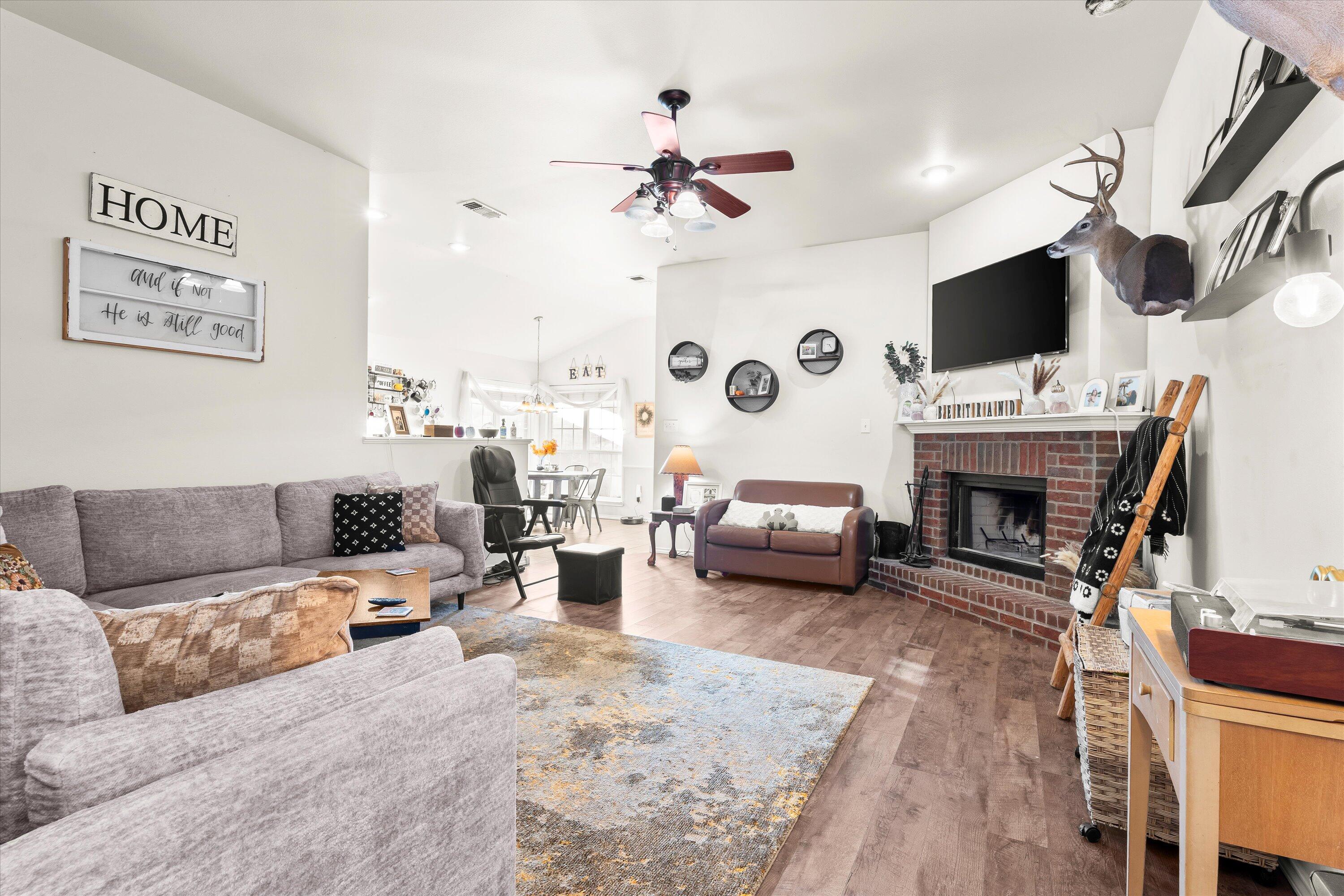 6513 85th Street Lubbock, TX 79424 - Photo 5 of 22 a living room with furniture and a flat screen tv