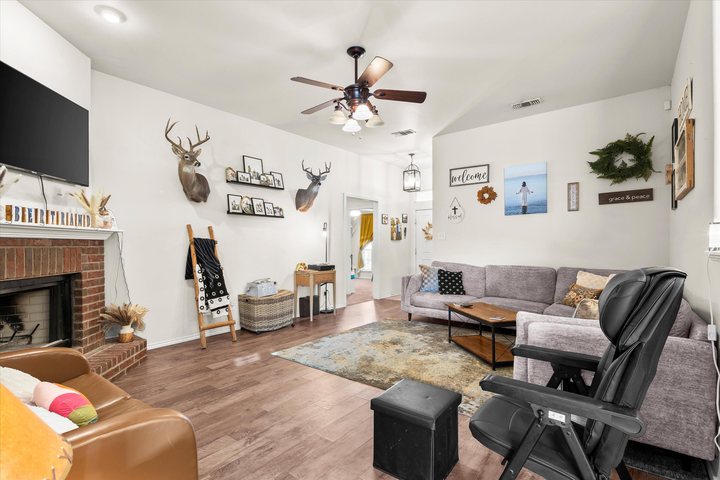 6513 85th Street Lubbock, TX 79424 - Photo 6 of 22 a living room with furniture and a fireplace