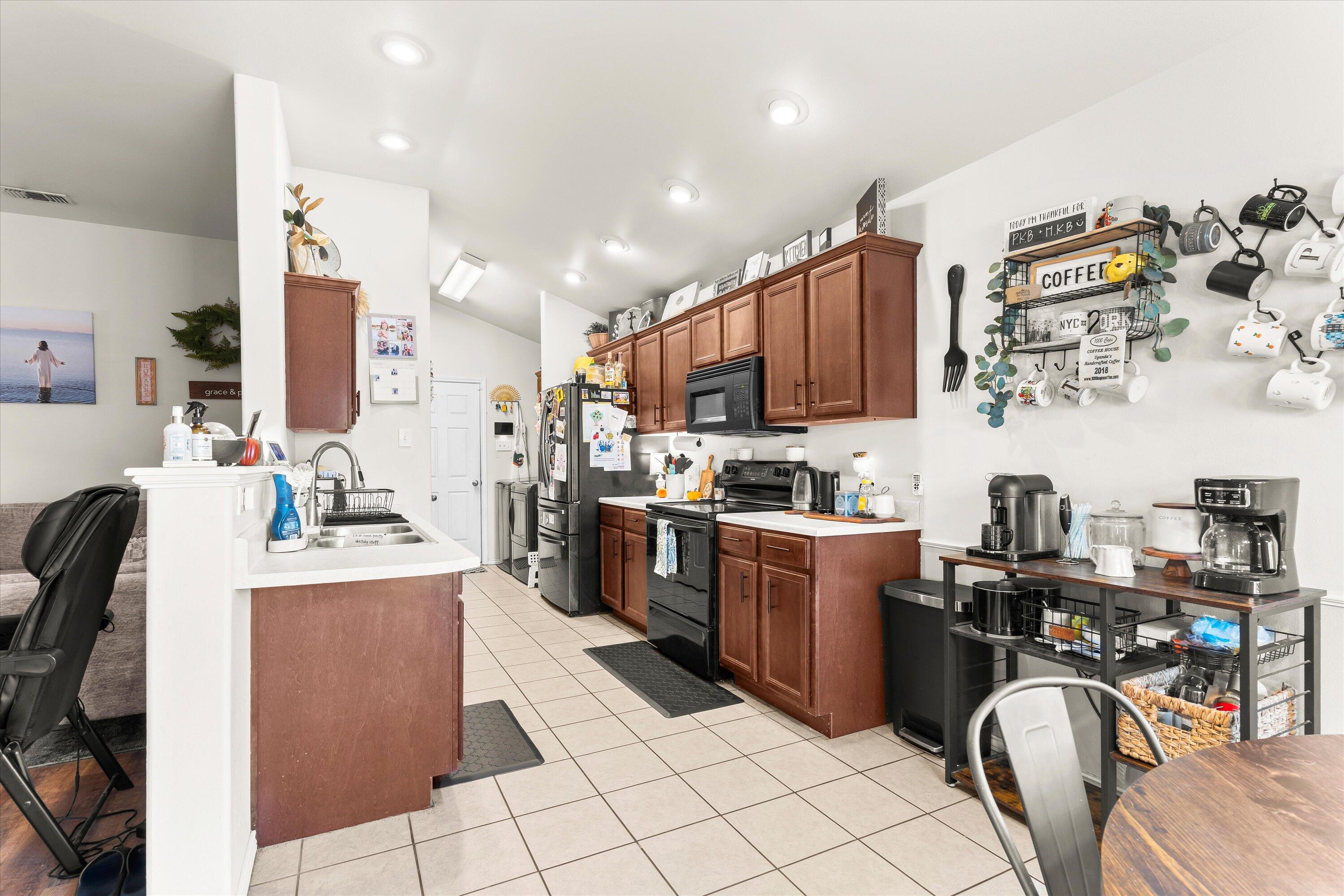 6513 85th Street Lubbock, TX 79424 - Photo 9 of 22 a kitchen with stainless steel appliances kitchen island granite countertop a sink and cabinets