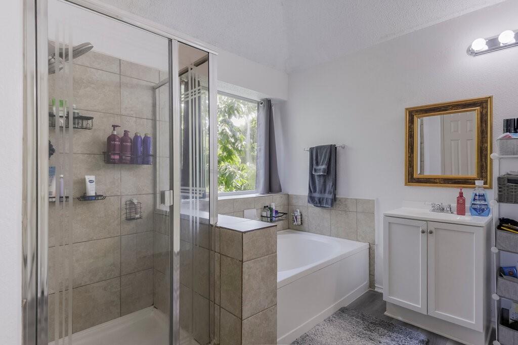 5428 Rolling Green Road Arlington, TX 76017 - Photo 18 of 29 Primary bath has separate shower and double vanities with sinks.