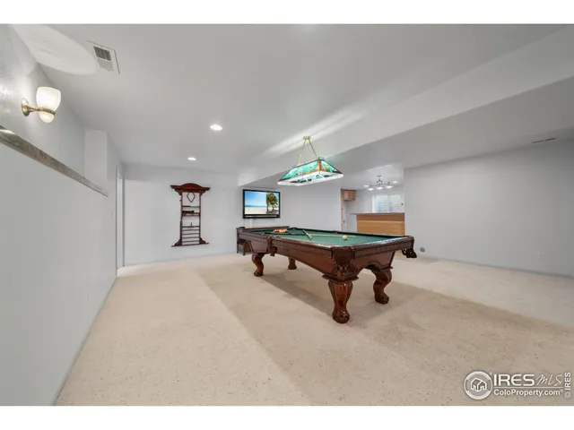 a room with pool table and windows