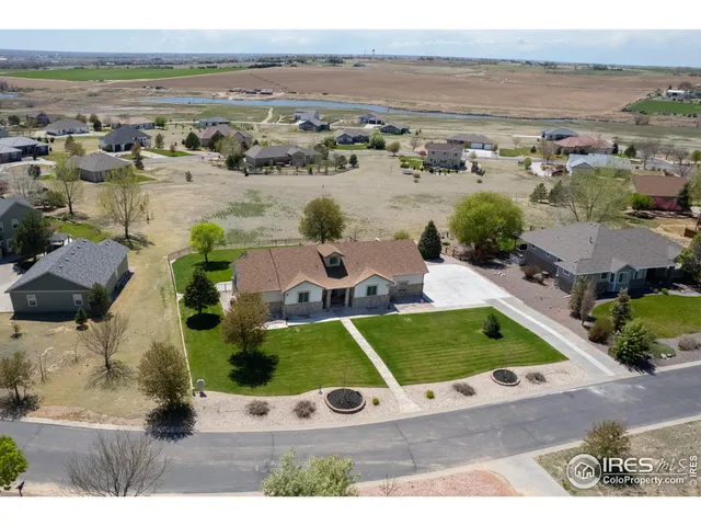 an aerial view of a house with yard swimming pool and ocean view
