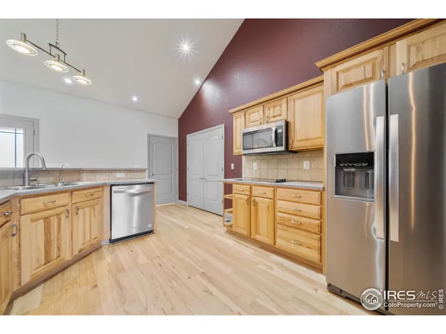 a kitchen with stainless steel appliances a refrigerator sink and microwave