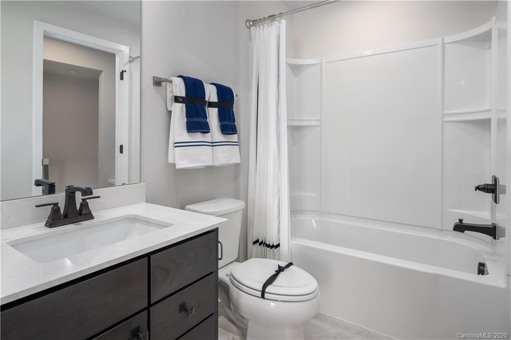 654 Crudent Road, Unit 1007A Tega Cay, SC 29708 - Photo 3 of 12 a bathroom with a sink a toilet and shower