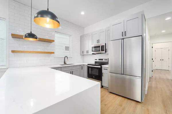 a kitchen with a refrigerator a sink and a stove