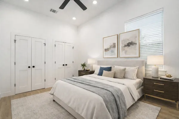 a bedroom with a bed and a painting on the wall