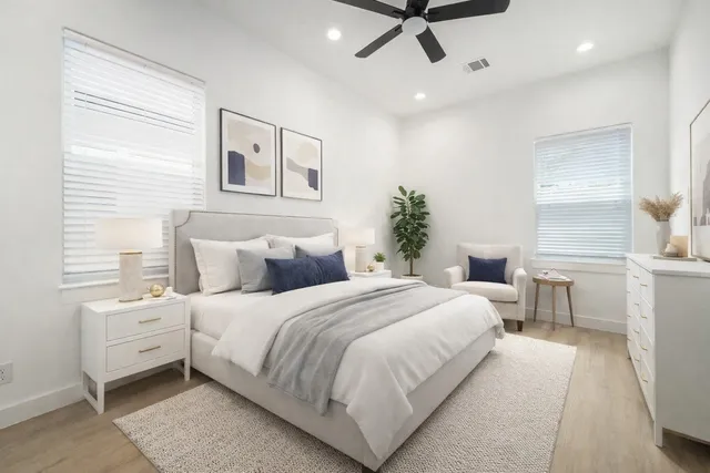a bedroom with a large bed and a chandelier