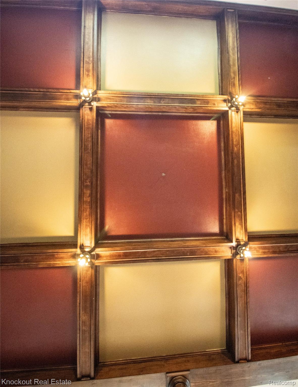 19983 West Ridge Road Henderson, MI 48841 - Photo 16 of 76 Coffered ceiling featuring rich wood trim, alternating red and cream-colored panels, and integrated accent lighting