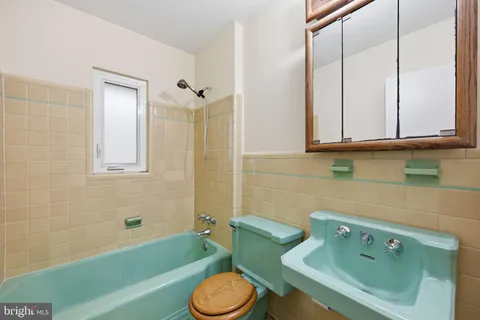 a bathroom with a sink a toilet and bathtub