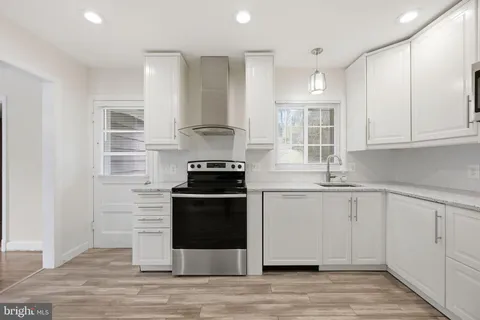 a kitchen with stainless steel appliances granite countertop a stove and a sink