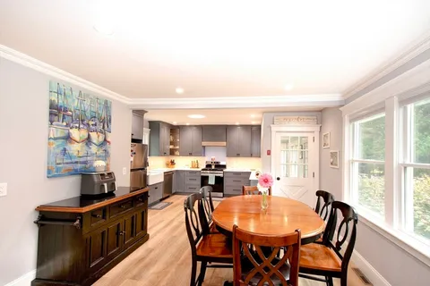 a view of a dining room with furniture and a window