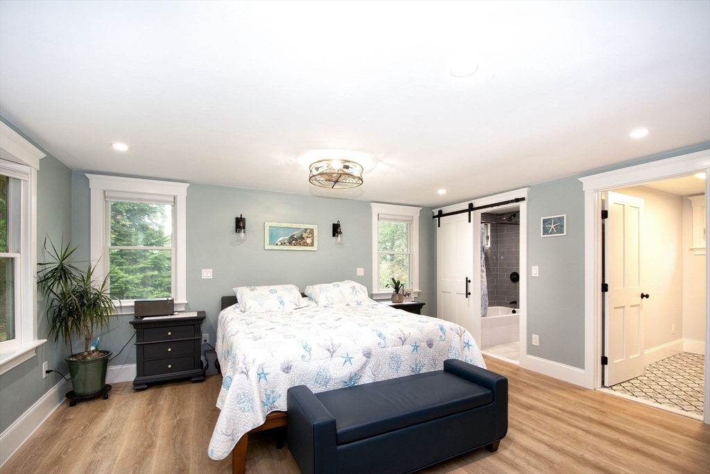 231 Main Street Kingston, MA 02364 - Photo 24 of 25 a bedroom with a bed and wooden floor