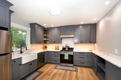 a kitchen with a sink cabinets and window