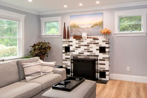 a living room with furniture and a fireplace
