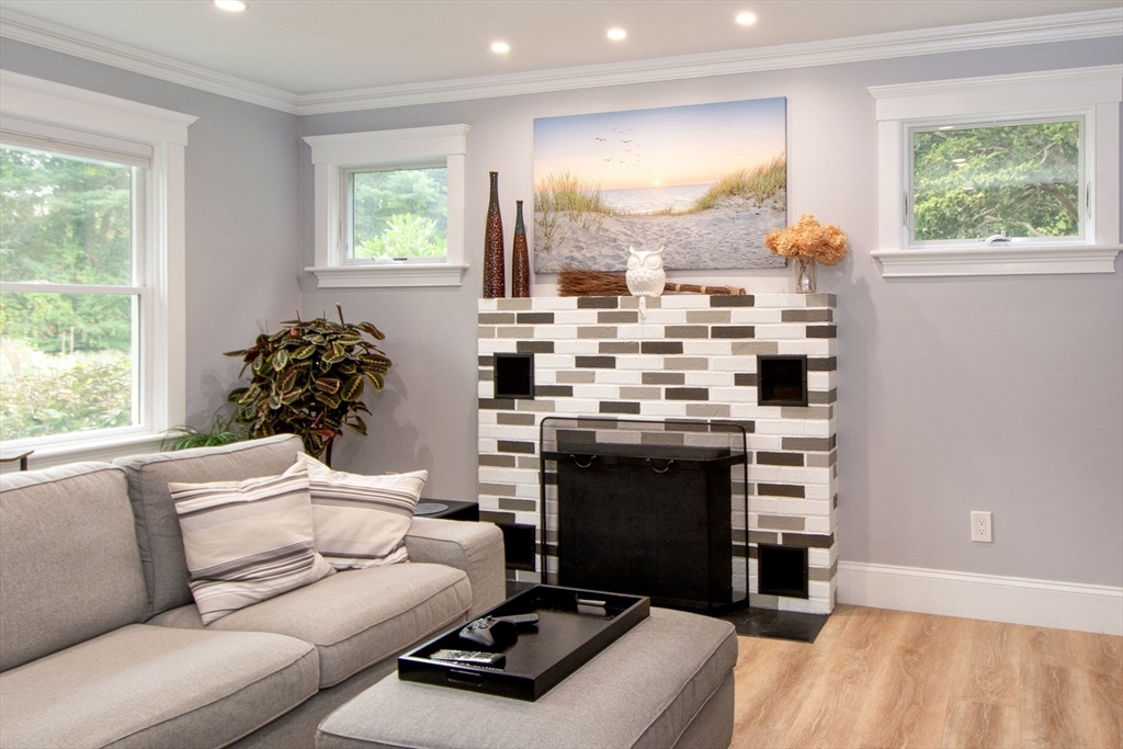 231 Main Street Kingston, MA 02364 - Photo 6 of 25 a living room with furniture and a fireplace