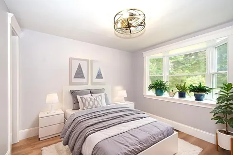 a bedroom with a large bed and a large window