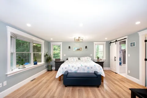 a bedroom with a large bed and a large window