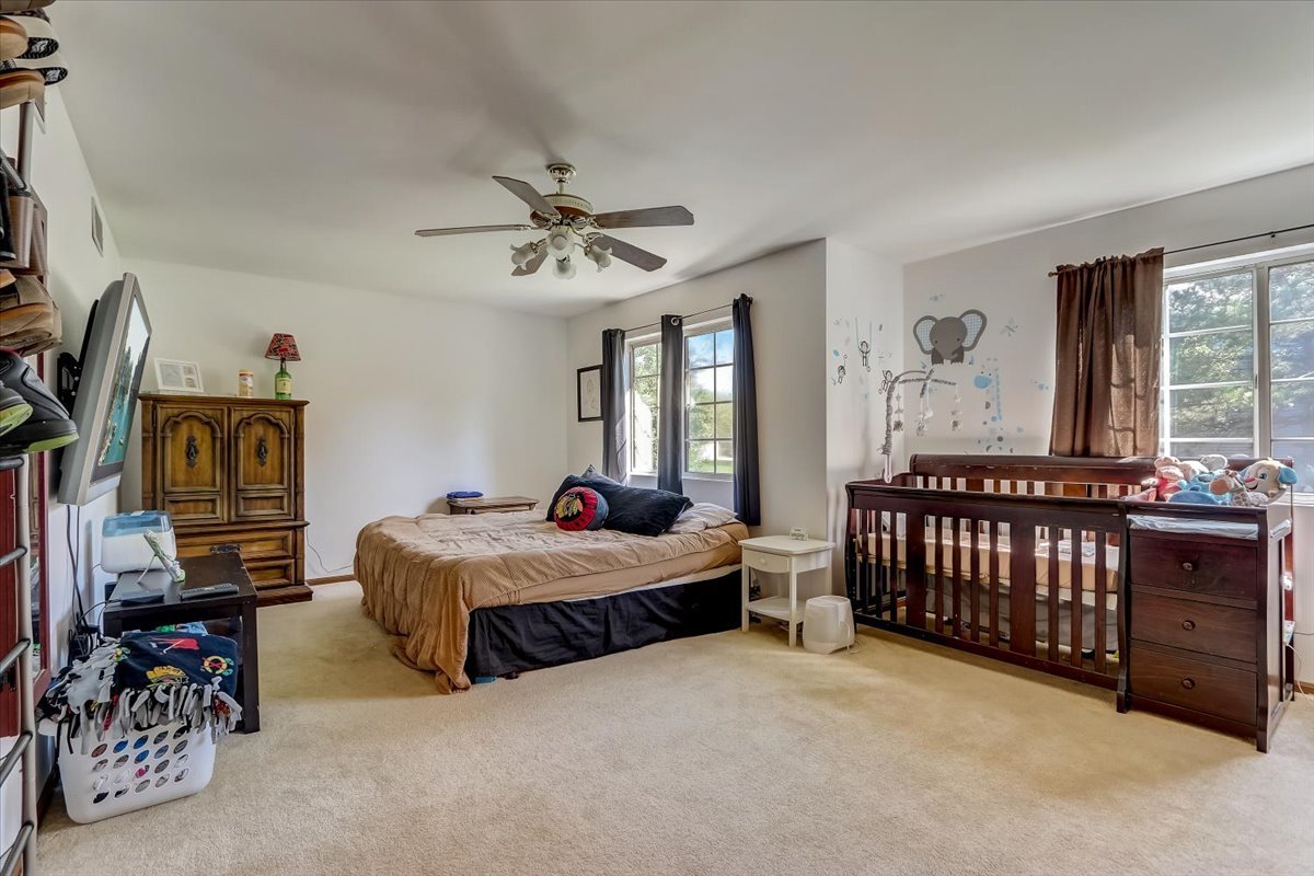 323 Village Creek Drive Lake In The Hills, IL 60156 - Photo 11 of 28 a bedroom with furniture and a window