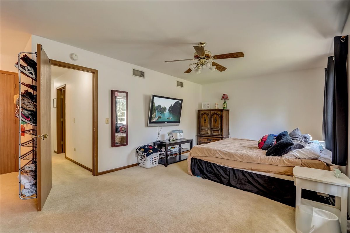 323 Village Creek Drive Lake In The Hills, IL 60156 - Photo 12 of 28 a bedroom with bed and ceiling fan