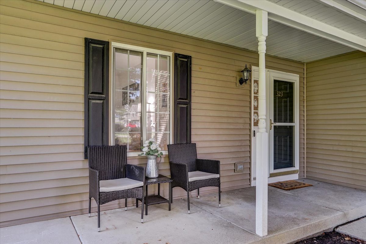 323 Village Creek Drive Lake In The Hills, IL 60156 - Photo 3 of 28 a front view of a house with outdoor seating