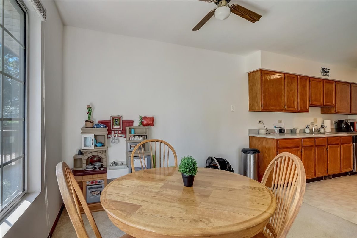 323 Village Creek Drive Lake In The Hills, IL 60156 - Photo 6 of 28 a kitchen with stainless steel appliances granite countertop a sink a microwave and wooden floors
