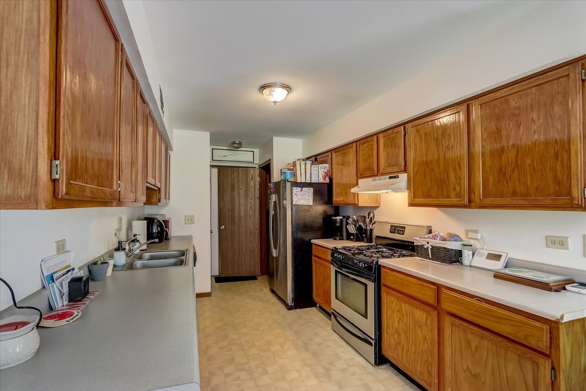 323 Village Creek Drive Lake In The Hills, IL 60156 - Photo 8 of 28 a kitchen with stainless steel appliances a sink a stove and a refrigerator