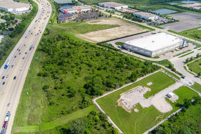 a view of a street with a big yard