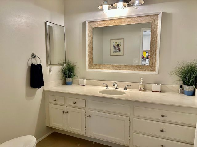 a bathroom with double sink and a mirror