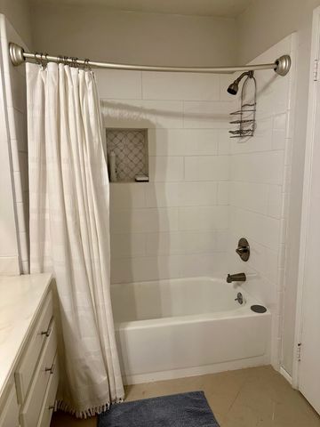 a bathroom with a shower and a tub