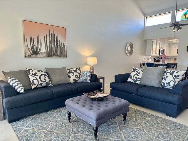 a living room with furniture couches and a night stand