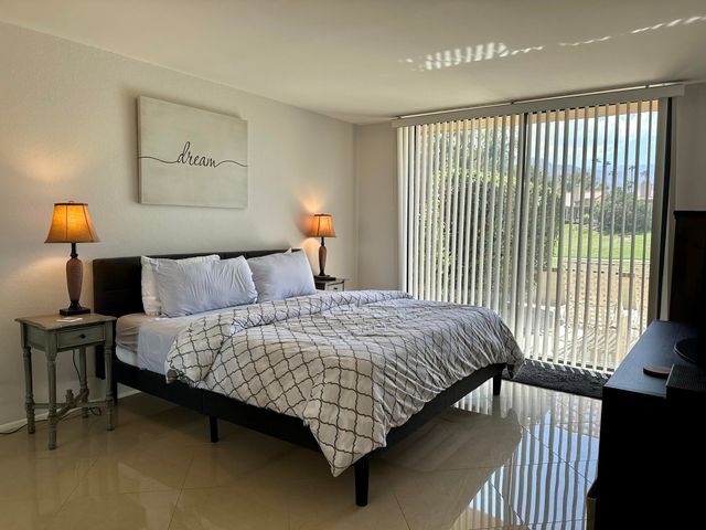 a bed sitting in a bedroom next to a lamp