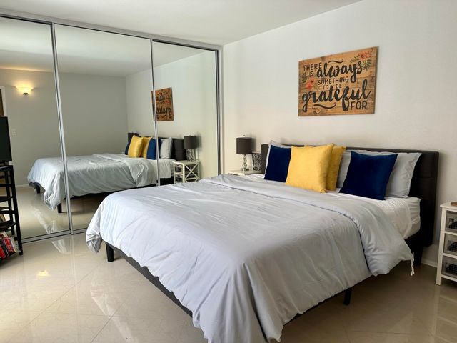 a bedroom with bed and a night stand