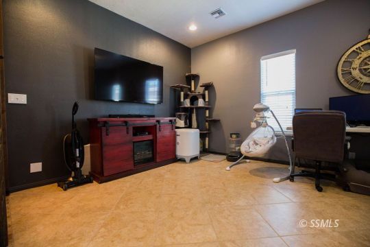 408 Acacia Street Ridgecrest, CA 93555 - Photo 16 of 32 a room with furniture and a flat screen tv
