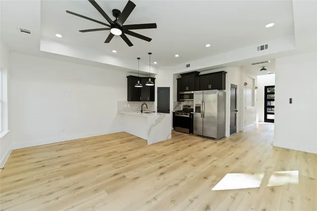 a view of kitchen with refrigerator microwave and cabinets