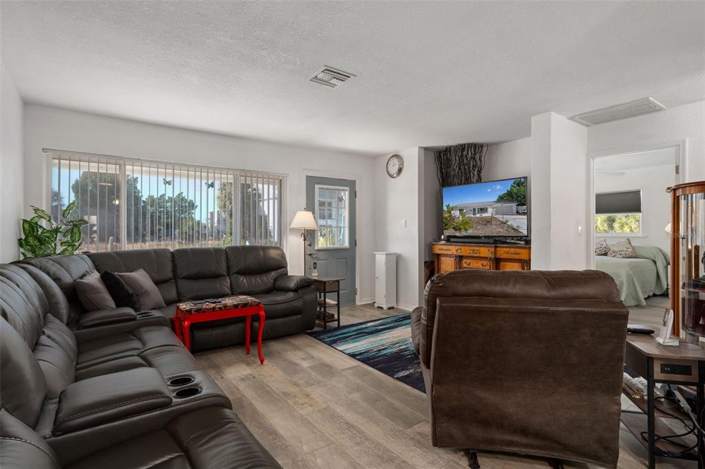 3320 Gardenia Drive Hernando Beach, FL 34607 - Photo 12 of 59 a living room with furniture and a flat screen tv