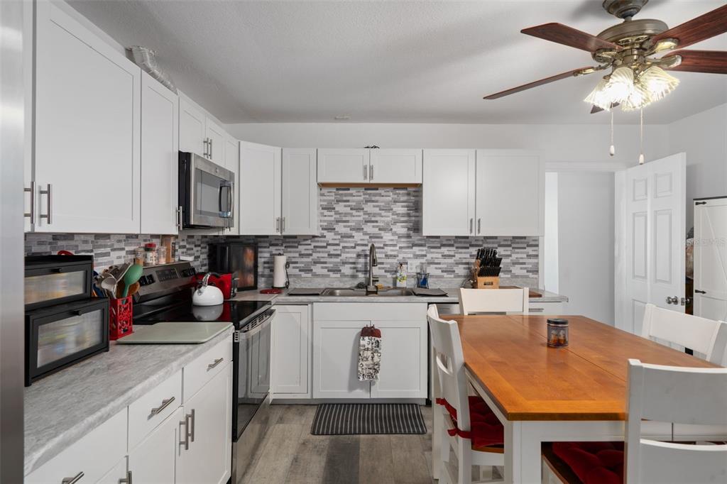 3320 Gardenia Drive Hernando Beach, FL 34607 - Photo 19 of 59 a kitchen with kitchen island granite countertop a sink a counter space stainless steel appliances and cabinets