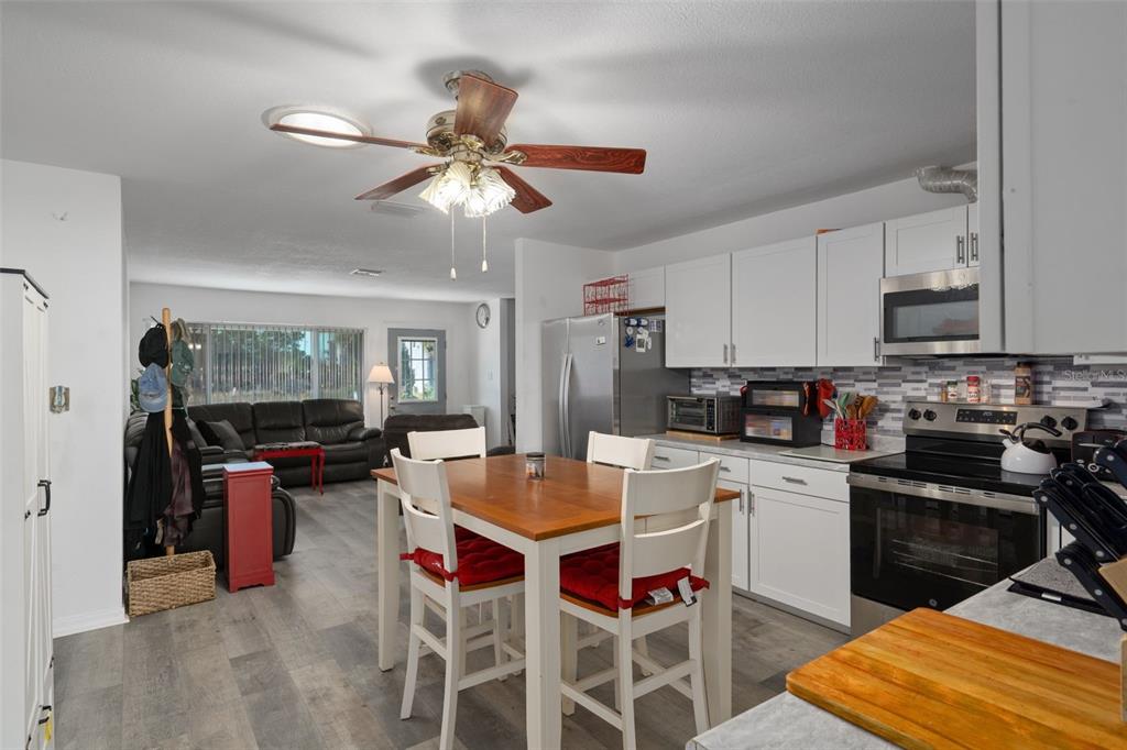 3320 Gardenia Drive Hernando Beach, FL 34607 - Photo 20 of 59 a kitchen with a dining table and chairs
