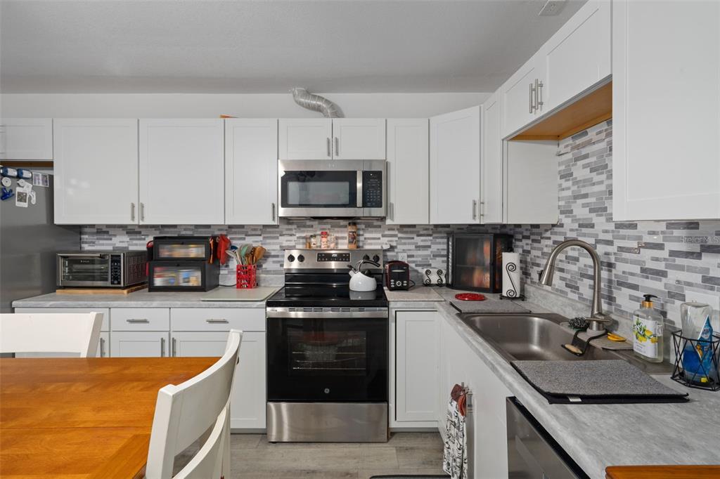 3320 Gardenia Drive Hernando Beach, FL 34607 - Photo 21 of 59 a kitchen with stainless steel appliances granite countertop a sink stove and refrigerator