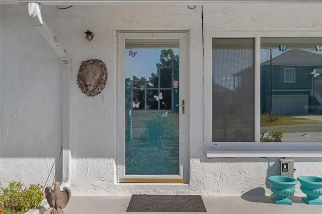a view of a door and chair in a living room
