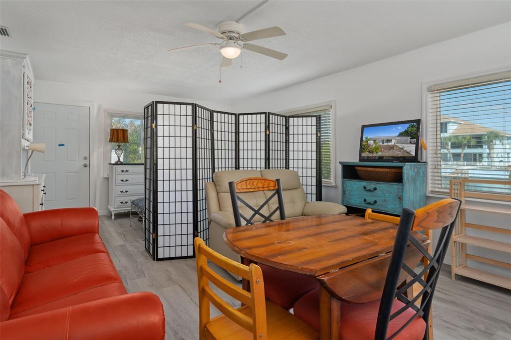 3320 Gardenia Drive Hernando Beach, FL 34607 - Photo 4 of 59 a outdoor living space with furniture a rug and a flat screen tv
