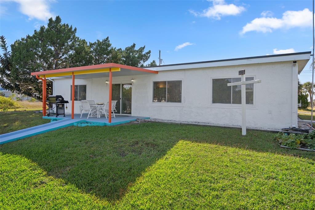 3320 Gardenia Drive Hernando Beach, FL 34607 - Photo 45 of 59 a view of a backyard with plants and a patio