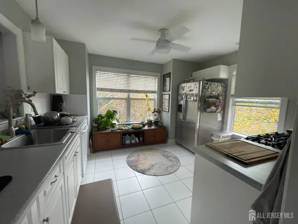 a kitchen with sink stove and refrigerator