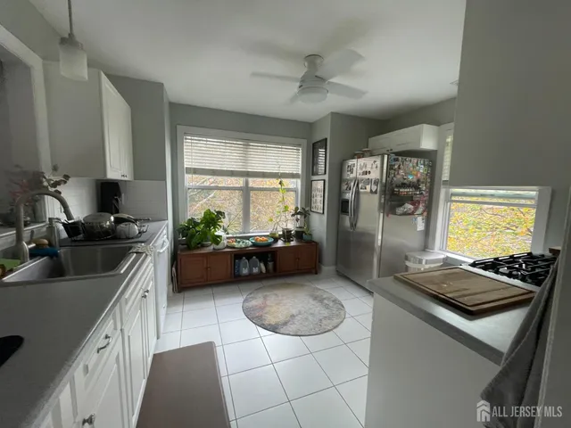 a kitchen with sink stove and refrigerator