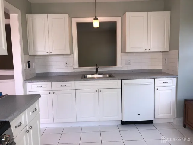 a kitchen with white cabinets